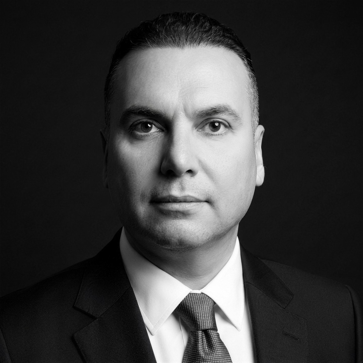 Dr. Hani Abdulqader, Chief Executive Officer of ATHEER PHARMA — black-and-white portrait
